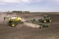 In this photo provided by Farm Rescue, volunteers plant crops on Paul Ivesdal's farm June 3, 2020 in Edmore, N.D. The wet spring offered only a tiny window for planting, so when Ivesdal fell ill to a coronavirus infection he knew the timing couldn't be worse. Thanks to Farm Rescue, Ivesdal got his crop in even as he was rushed to a hospital and spend eight days on a ventilator. The nonprofit organization's help meant that although Ivesdal spent a summer in rehabilitation to recover his walking ability and even now tires more easily, he'll be able to keep farming. (Dan Erdmann/Farm Rescue via AP)