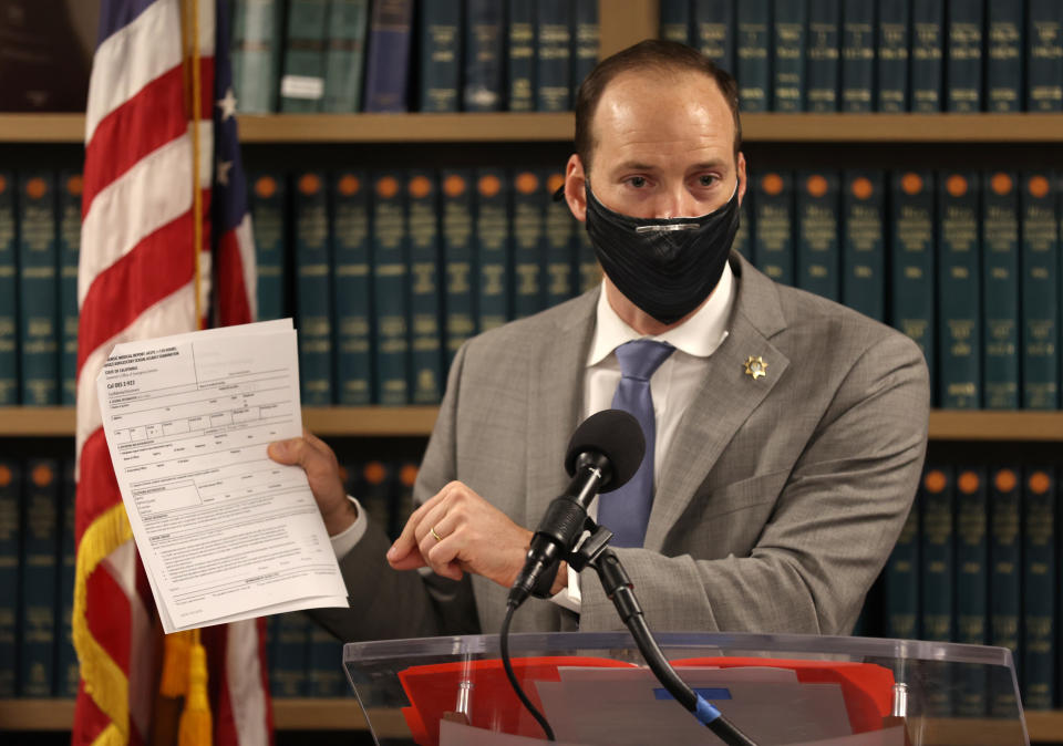 SAN FRANCISCO, CALIFORNIA - FEBRUARY 15: San Francisco District Attorney Chesa Boudin holds up a copy of the California State medical examination form for sexual assault victims as he speaks during a press conference at his office on February 15, 2022 in San Francisco, California. San Francisco D.A. Chesa Boudin spoke out against the San Francisco Police Department's practice of logging DNA evidence from rape kits into their crime database to use as evidence in other crimes.  (Photo by Justin Sullivan/Getty Images)