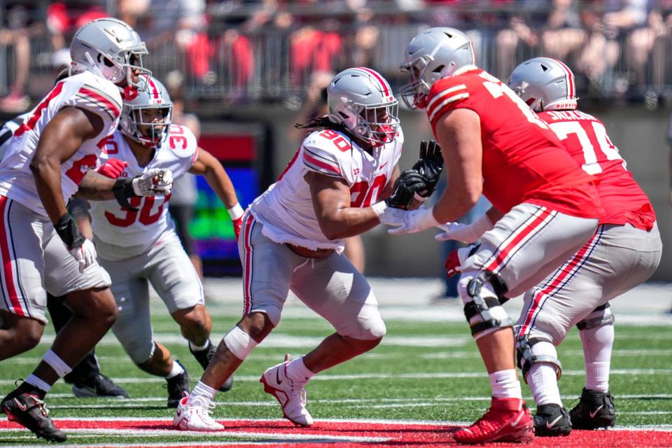 Apr 15, 2023; Columbus, Ohio, United States;  Ohio State Buckeyes defensive tackle Jaden McKenzie (90) lines up with Ohio State Buckeyes offensive lineman Donovan Jackson (74) during the second quarter of the Ohio State Buckeyes spring game at Ohio Stadium on Saturday morning. Mandatory Credit: Joseph Scheller-The Columbus Dispatch