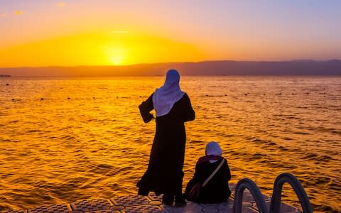 Women survey the small section of coastline that belongs to Jordan - Credit: ALAMY