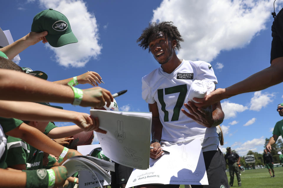 New York Jets wide receiver Garrett Wilson signs autographs after drills at the NFL football team's practice facility Saturday, July 30, 2022, in Florham Park, N.J. (AP Photo/Julia Nikhinson)