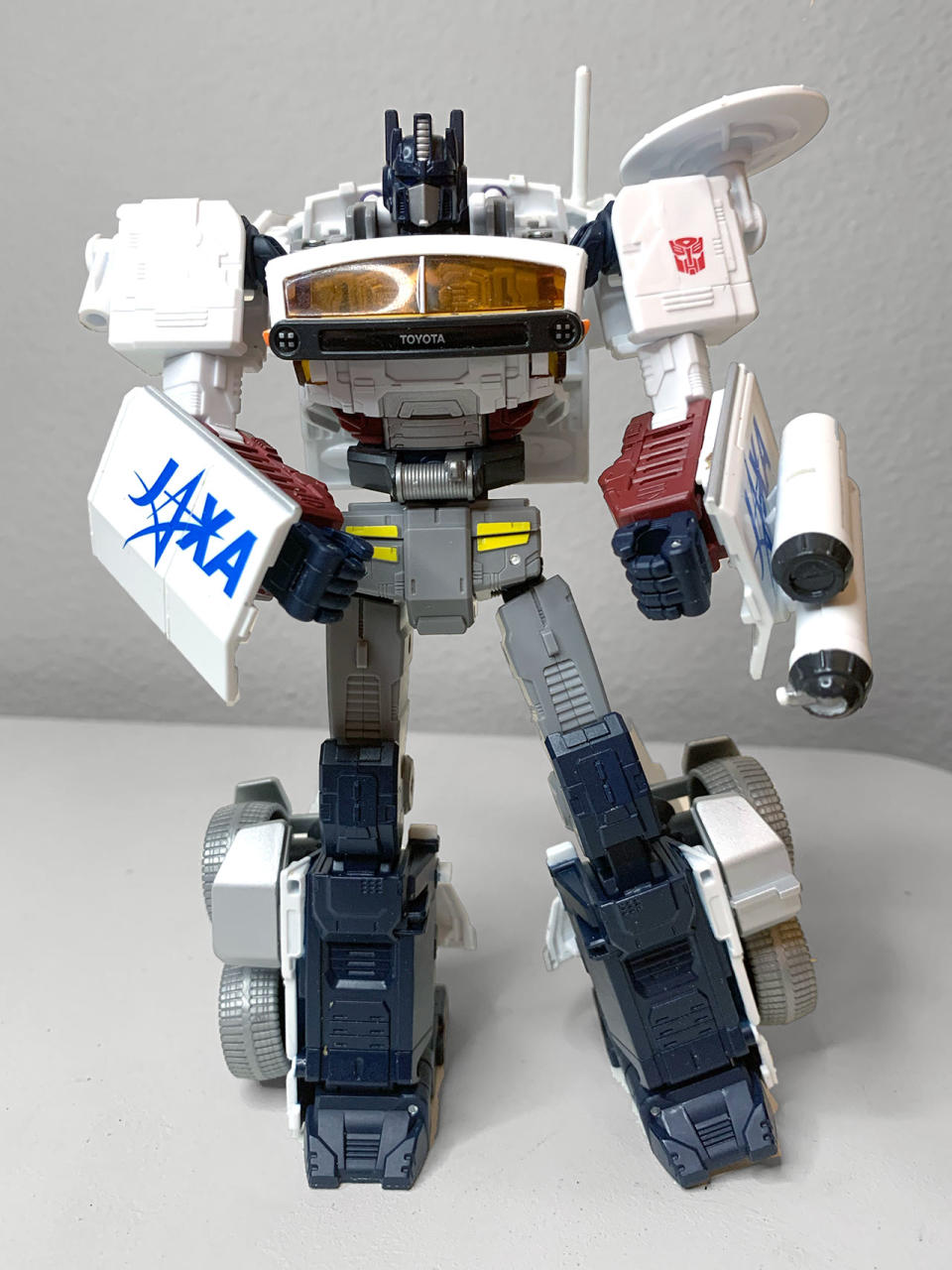 closeup of a transformer toy standing on a grayish-white table