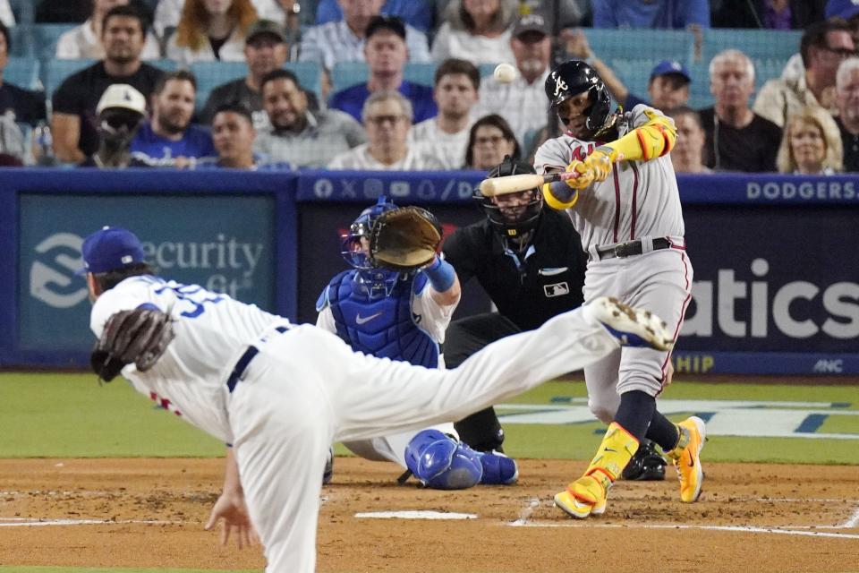 Atlanta Braves' Ronald Acuna Jr., right, hits a grand slam as Los Angeles Dodgers starting pitcher Lance Lynn, left, watches along with catcher Will Smith, second from left, and home plate umpire Dan Bellino during the second inning of a baseball game Thursday, Aug. 31, 2023, in Los Angeles. (AP Photo/Mark J. Terrill)