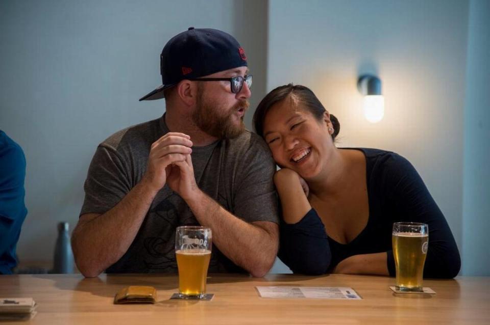 Patrick Forrey and Kaitln Lehr enjoy a beer at the grand opening of the Bike Dog Brewing Company taproom next to Sellend’s at 915 Broadway in 2017.
