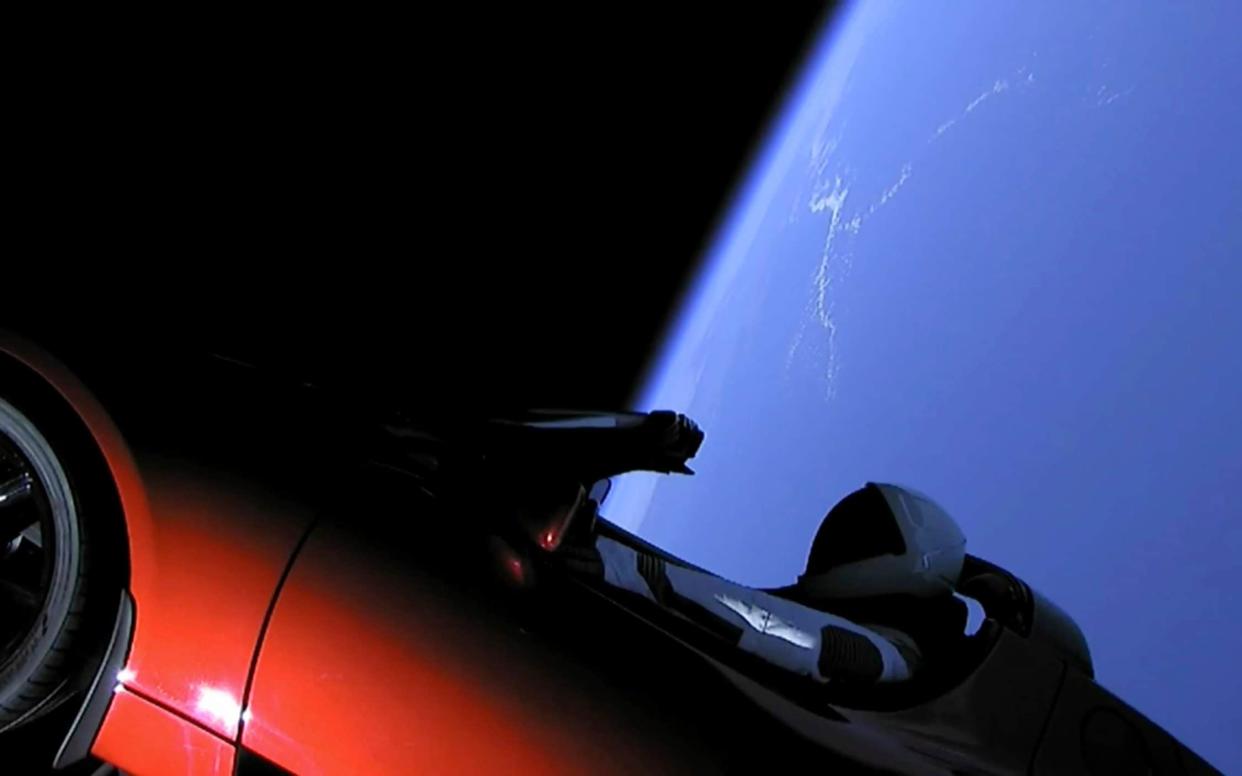 The car - with its 'Starman' model in the driver's seat - enters space - SpaceX