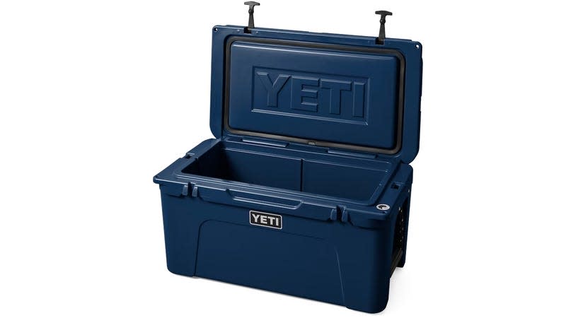 A blue Yeti Tundra cooler with its lid open.