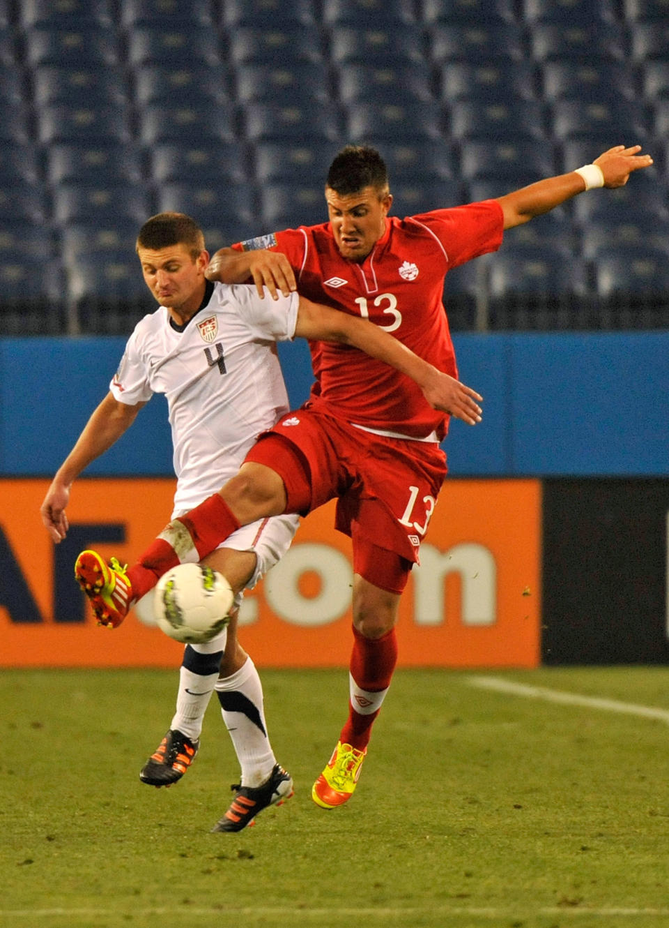 NASHVILLE, TN - MARCH 24: Lucas Cavallini #13 of Canada and Perry Kitchen #4 of the USA jump for a ball in a 2012 CONCACAF Men's Olympic Qualifying match at LP Field on March 24, 2012 in Nashville, Tennessee. (Photo by Frederick Breedon/Getty Images)