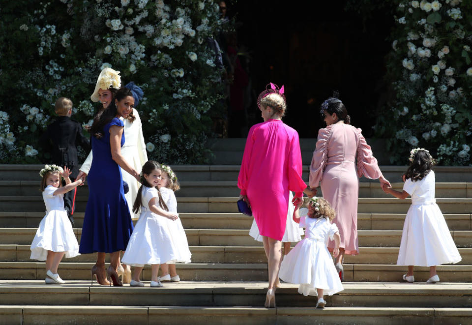 Charlotte is spotted on the far left waving before the ceremony. (Photo: Getty Images)