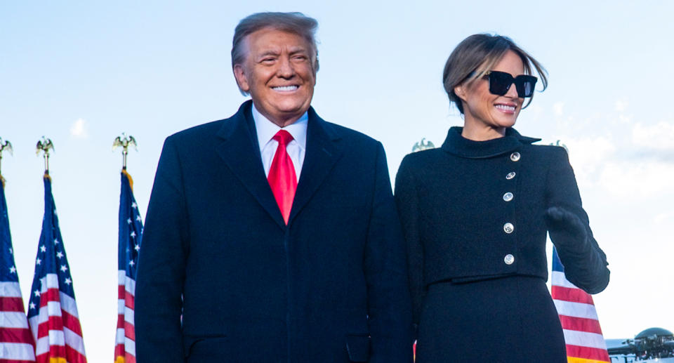 Donald Trump and wife Melania smiling for supporters. 