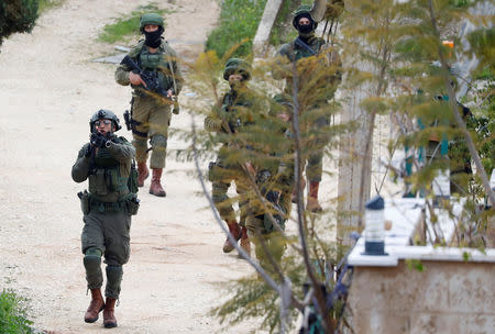 Israeli forces search for a Palestinian gunman near Nablus, in the Israeli-occupied West Bank March 17, 2019. REUTERS/Mohamad Torokman