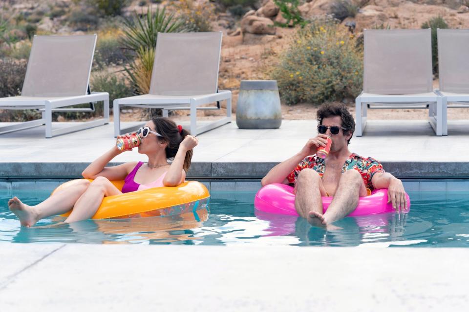 Cristin Milioti, Andy Samberg sitting in tubes while floating in the pool and drinking