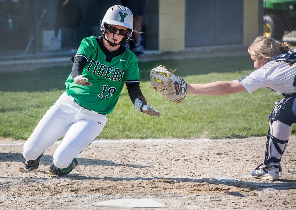 Yorktown's Katelyn Knott attempts to slide home against Delta during their game at Delta High School Friday, April 23, 2021. 