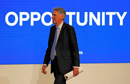 Britain's Chancellor of the Exchequer Philip Hammond walks on to the stage before delivering his keynote address at the Conservative Party Conference in Birmingham, Britain, October 1, 2018. REUTERS/Toby Melville