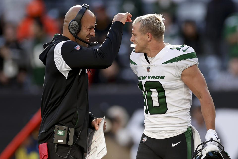 New York Jets wide receiver Braxton Berrios (10) is congratulated by New York Jets head coach Robert Saleh after scoring a touchdown against the Miami Dolphins during the fourth quarter of an NFL football game, Sunday, Oct. 9, 2022, in East Rutherford, N.J. (AP Photo/Adam Hunger)