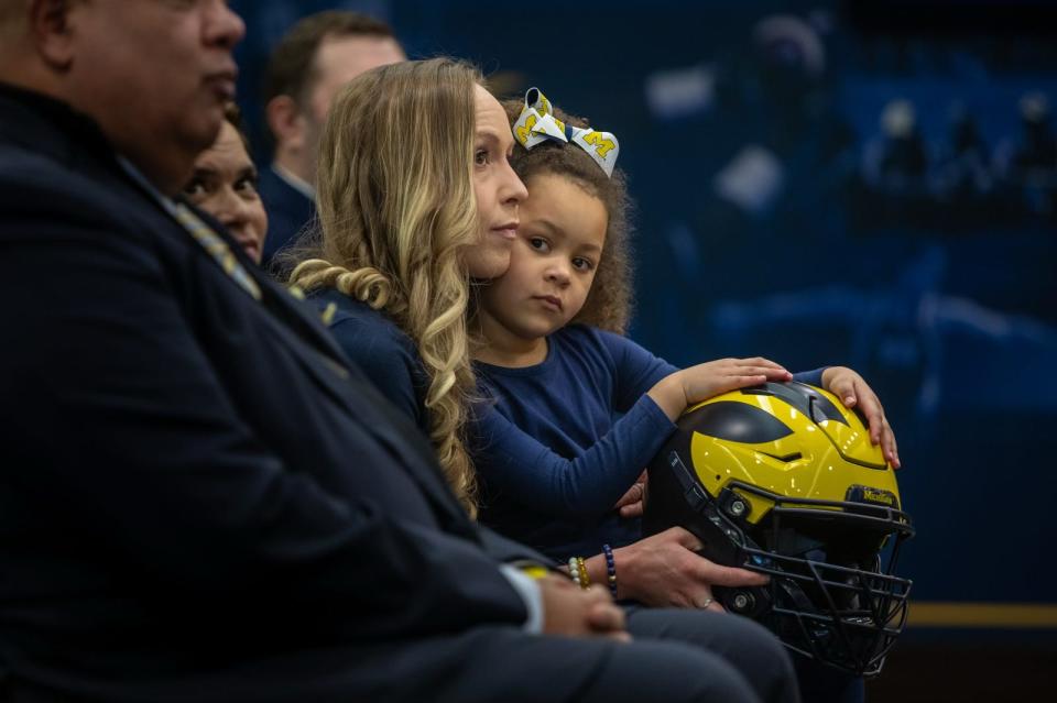 Sherrone Moore’s wife Kelli Moore and daughter sit during a press conference inside the Junge Family Champions Center in Ann Arbor on Saturday, Jan. 27, 2024.