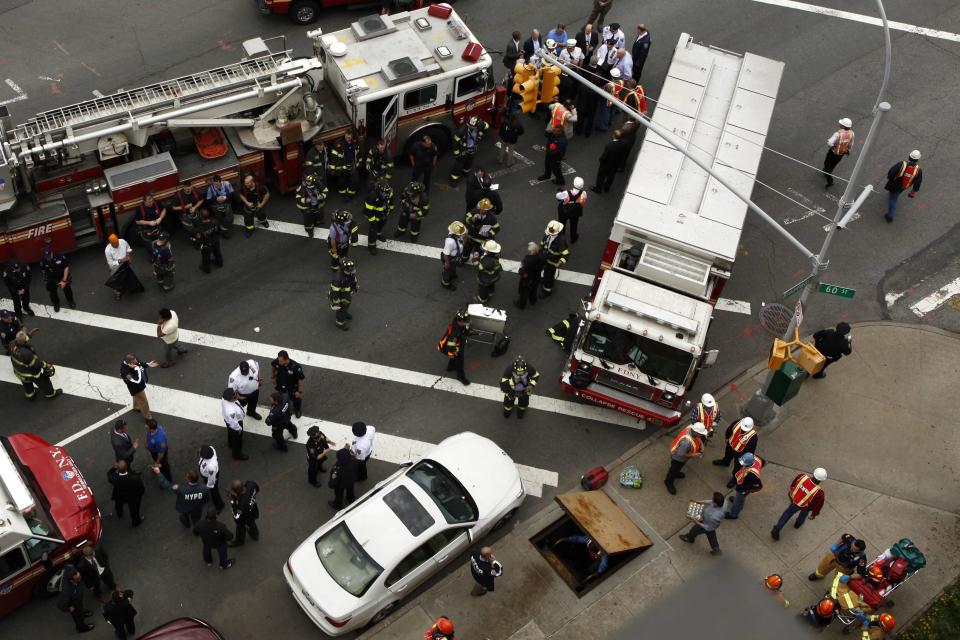 New York City firefighters and Metropolitan Transportation Authority (MTA) workers attend an emergency during a derailed F train in Woodside, New York, May 2, 2014. A New York City subway train carrying 1,000 riders derailed on Friday morning while traveling through a tunnel in the borough of Queens, injuring 19 people, city fire officials said. Fifteen people escaped with minor injuries while four more were transported to a hospital with potentially serious injuries, officials said. (REUTERS/Eduardo Munoz)