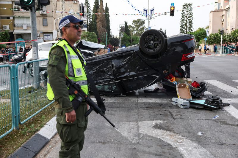 Israeli security forces secure the area where a suspected stabbing incident took place, in Ramle