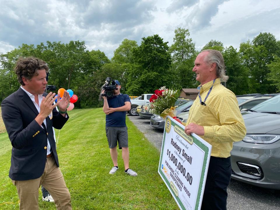 Howie Guja of the Publishers Clearing House Prize Patrol talked with Rodney Small of Chambersburg after giving him a giant check for his $1 million win in the PCH Lotto.