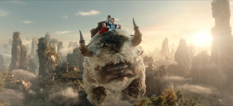 Gordon Cormier as Aang, Ian Ousley as Sokka, Kiawentiio as Katara riding Appa in season 1 of Avatar: The Last Airbender