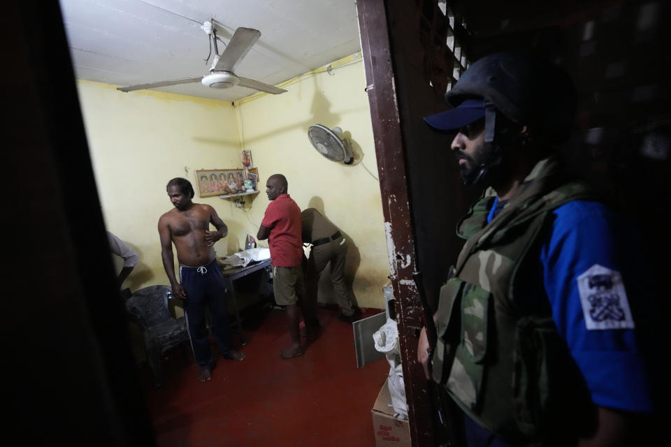 Sri Lankan police and Navy personnel search a house for proscribed substances as part of a month-long operation against narcotics in Colombo, Sri Lanka, Thursday, Jan. 18, 2024. (AP Photo/Eranga Jayawardena)