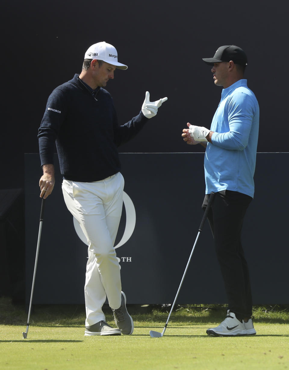 England's Justin Rose, left, speaks to Brooks Koepka of the United States on the 1st tee before they start their third round in British Open Golf Championships at Royal Portrush in Northern Ireland, Saturday, July 20, 2019.(AP Photo/Jon Super)