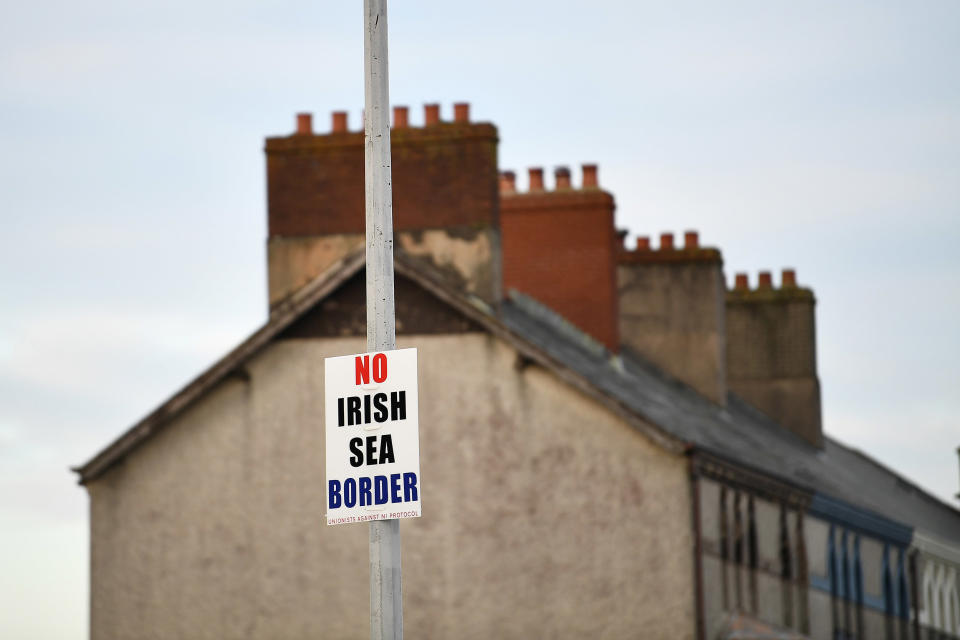 Image: A sign reading 'No Irish Sea border' is seen affixed to a lamp post in the Port of Larne, Northern Ireland (Clodagh Kilcoyne / Reuters file)