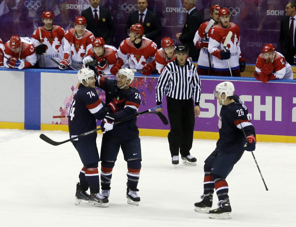 USA forward T.J. Oshie is congratulated by USA forward Ryan Callahan and forward Paul Stastny after Oshie scored the winning goal in a shootout against Russia during overtime of a men's ice hockey game at the 2014 Winter Olympics, Saturday, Feb. 15, 2014, in Sochi, Russia. (AP Photo/Morry Gash)