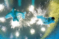 LONDON, ENGLAND - AUGUST 01: (L-R) Kai Qin and Yutong Luo of China compete in the Men's Synchronised 3m Springboard final on Day 5 of the London 2012 Olympic Games at the Aquatics Centre on August 1, 2012 in London, England. (Photo by Clive Rose/Getty Images)