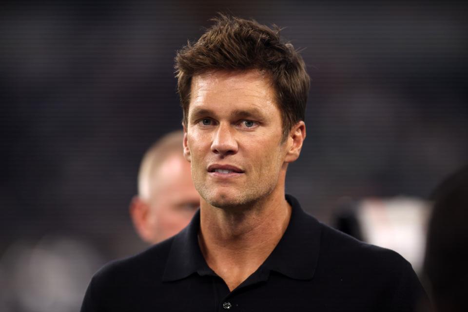 Tom Brady hangs out on the field before a preseason game between the Dallas Cowboys and Las Vegas Raiders at AT&T Stadium on Aug. 26, 2023.