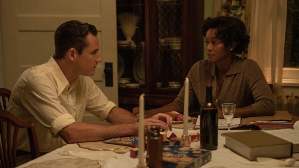 A press image of Calvin and Harriet sitting at a table together in Lessons in Chemistry.