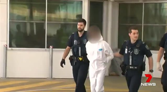 One of the accused teenagers is walking into the Youth Court in handcuffs. Photo: 7 News