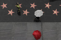 <p>A superhero impersonator stands on the Hollywood Walk of Fame as it rains Wednesday, Jan. 16, 2019, in the Hollywood section of Los Angeles. Numerous vehicles have collided in a foggy mountain pass as a storm system passes through Southern California. (AP Photo/Jae C. Hong) </p>