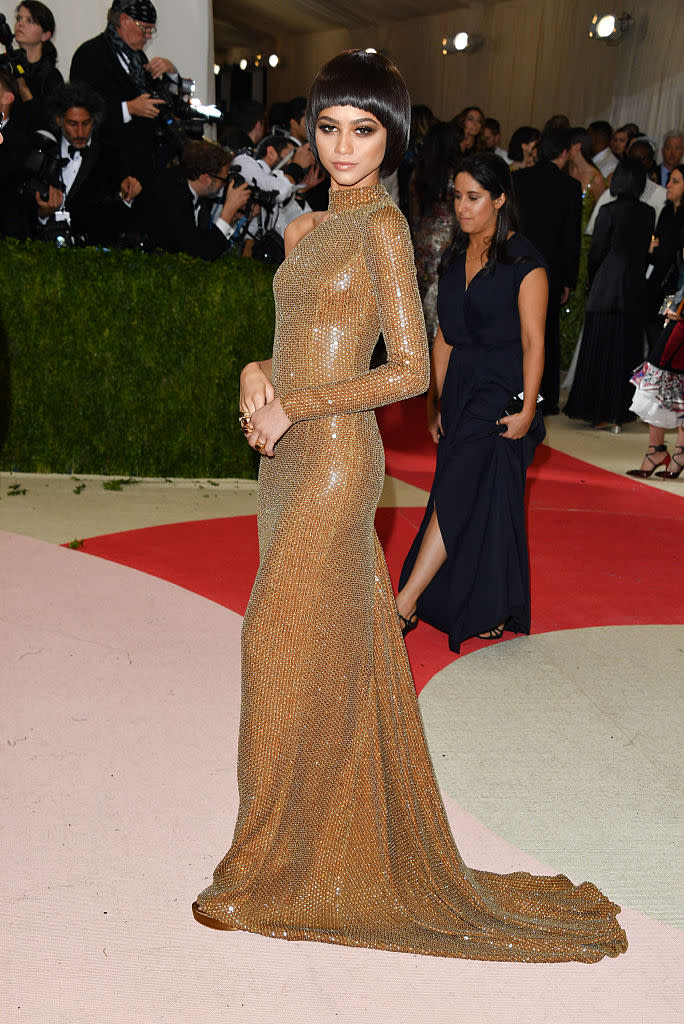 <p>Zendaya proved she’s a pro when it comes to gracing the red carpet as she chose a gold gown by Michael Kors for the 2015 Met Gala. <em>[Photo: Getty]</em> </p>