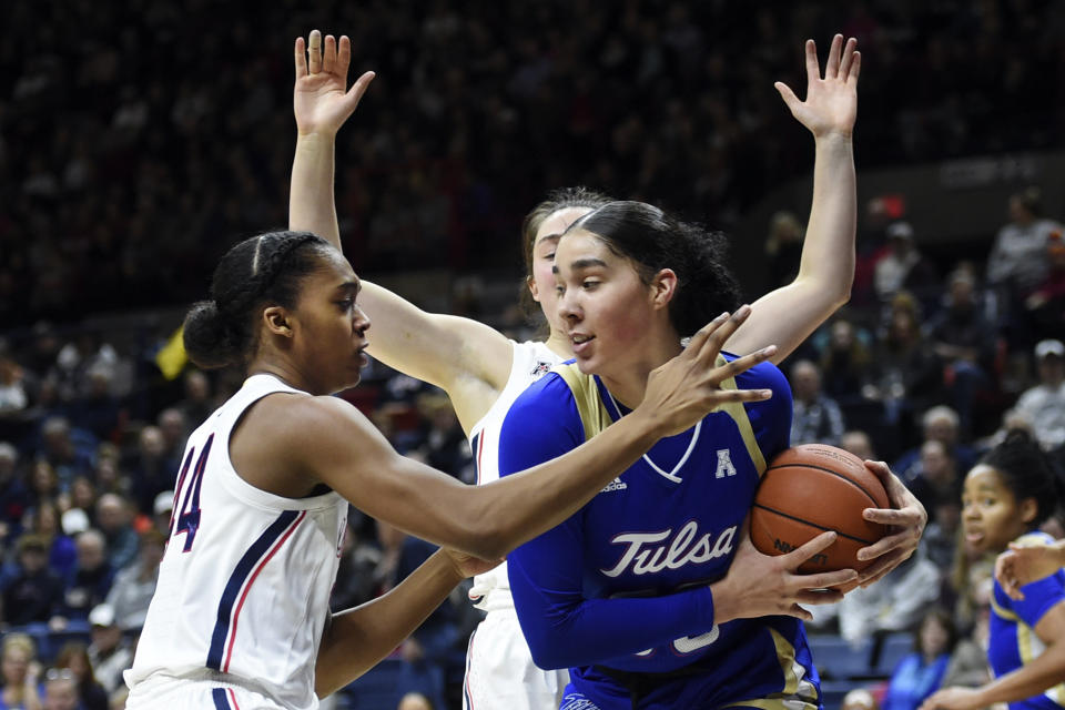 Tulsa's Kendrian Elliott (00) grabs a rebound from Connecticut's Aubrey Griffin (44) during the first half of an NCAA college basketball game Sunday, Jan. 19, 2020, in Storrs, Conn. (AP Photo/Stephen Dunn)