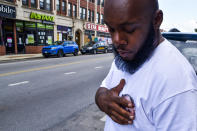 Nathan Wallace stands outside of his home wearing a button showing his daughter, Natalia Wallace, on Monday, Aug. 3, 2020, in Chicago. Natalia, 7, was killed on the west side of Chicago on July 4, 2020. (AP Photo/Matt Marton)