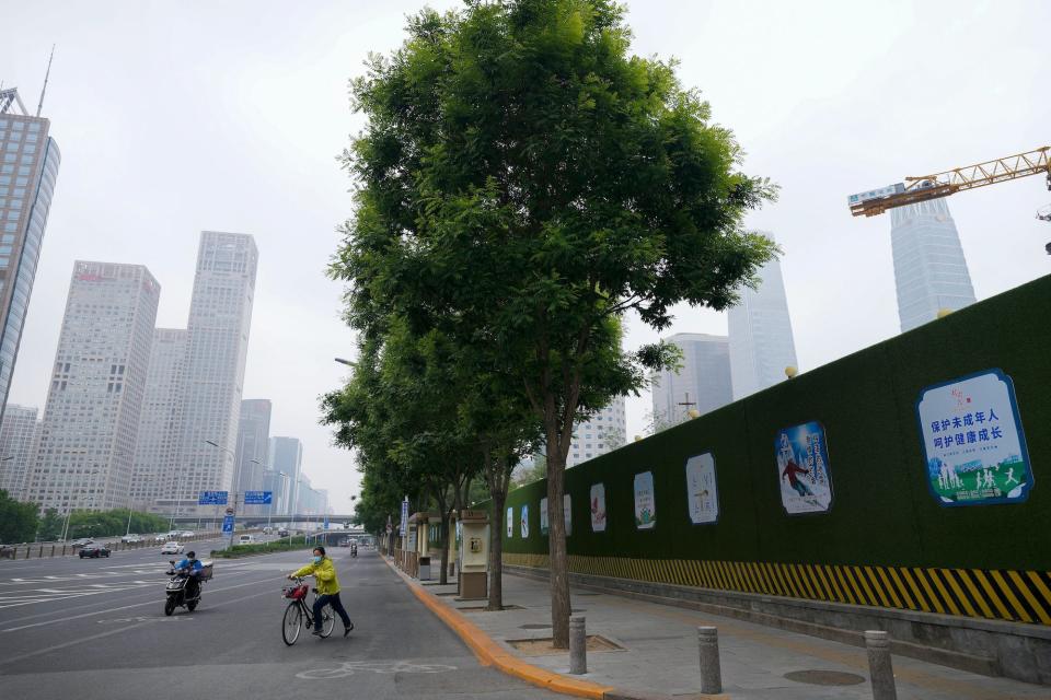 Two cyclists on a quiet road in Shanghai