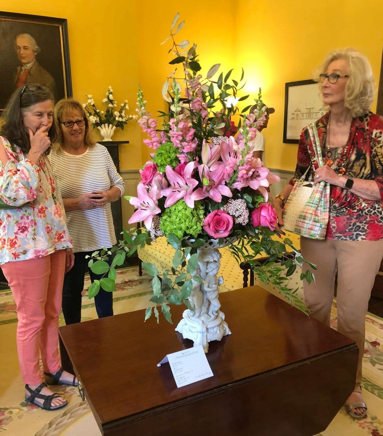 Historic Garden Week home and garden tour ticket holders admire a floral design at historic Battersea plantation in Petersburg on April 26, 2022.