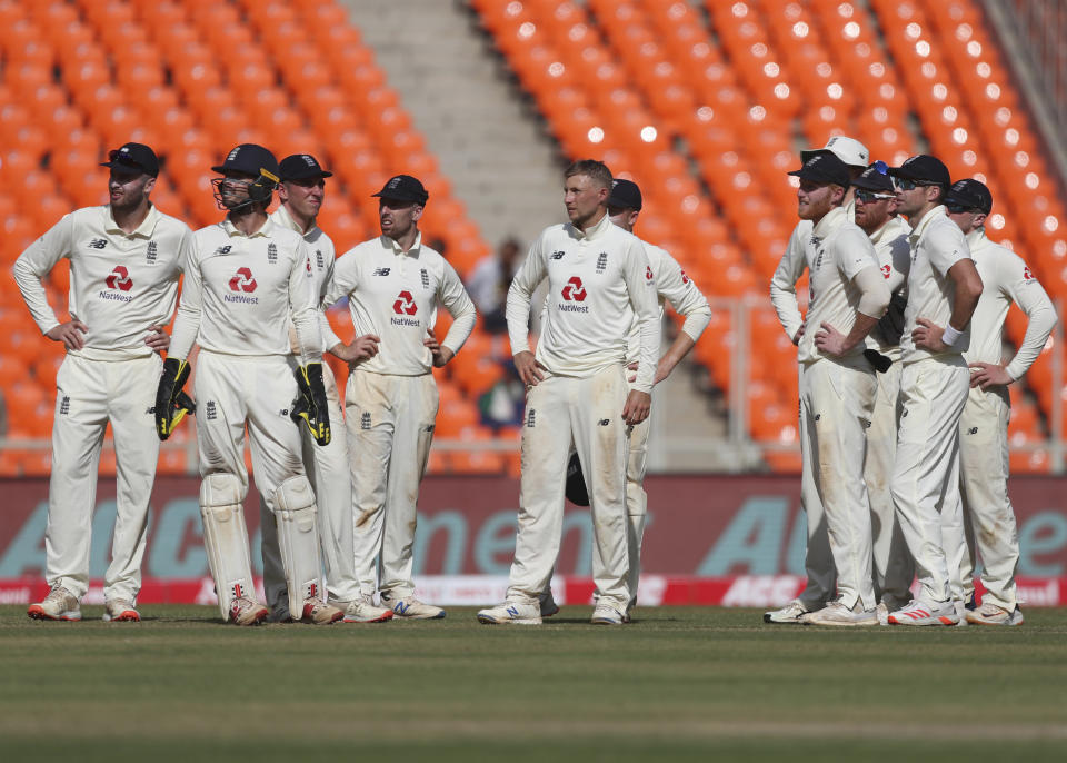 England's captain Joe Root, center, and teammates await third umpire's decision for the wicket of India's Rishabh Pant during the second day of fourth cricket test match between India and England at Narendra Modi Stadium in Ahmedabad, India, Friday, March 5, 2021. (AP Photo/Aijaz Rahi)