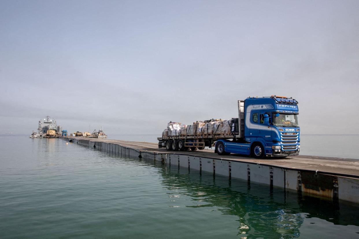 <span>A truck carries humanitarian aid across a makeshift pier off the Gaza Strip on 19 May 2024.</span><span>Photograph: US Army Central via Reuters</span>