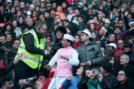 A steward asks a spectator to stop dancing and sit down at Wembley Stadium attended by India's Prime Minister Narendra Modi, in London, November 13, 2015. REUTERS/Suzanne Plunkett