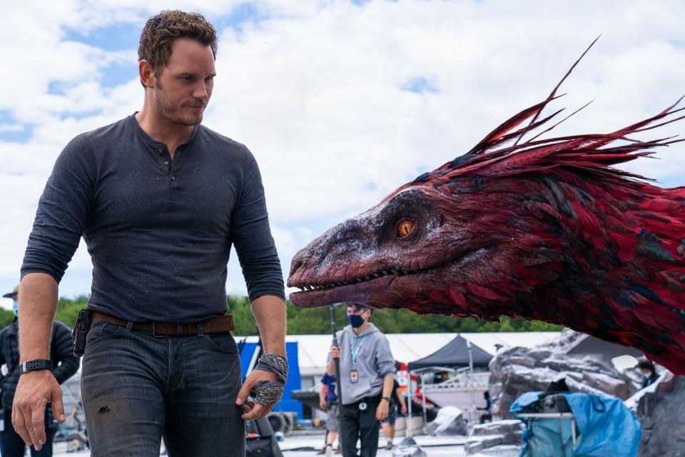 Chris Pratt shares a moment with an animatronic dinosaur on the set of "Jurassic World Dominion."