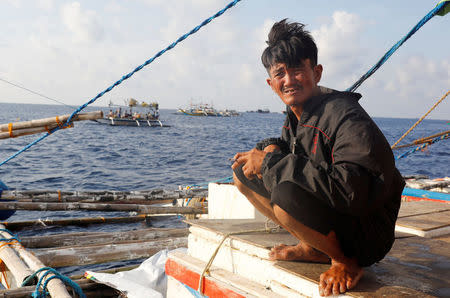A Filipino fisherman rests aboard a fishing boat at the disputed Scarborough Shoal April 6, 2017. Picture taken April 6, 2017 REUTERS/Erik De Castro