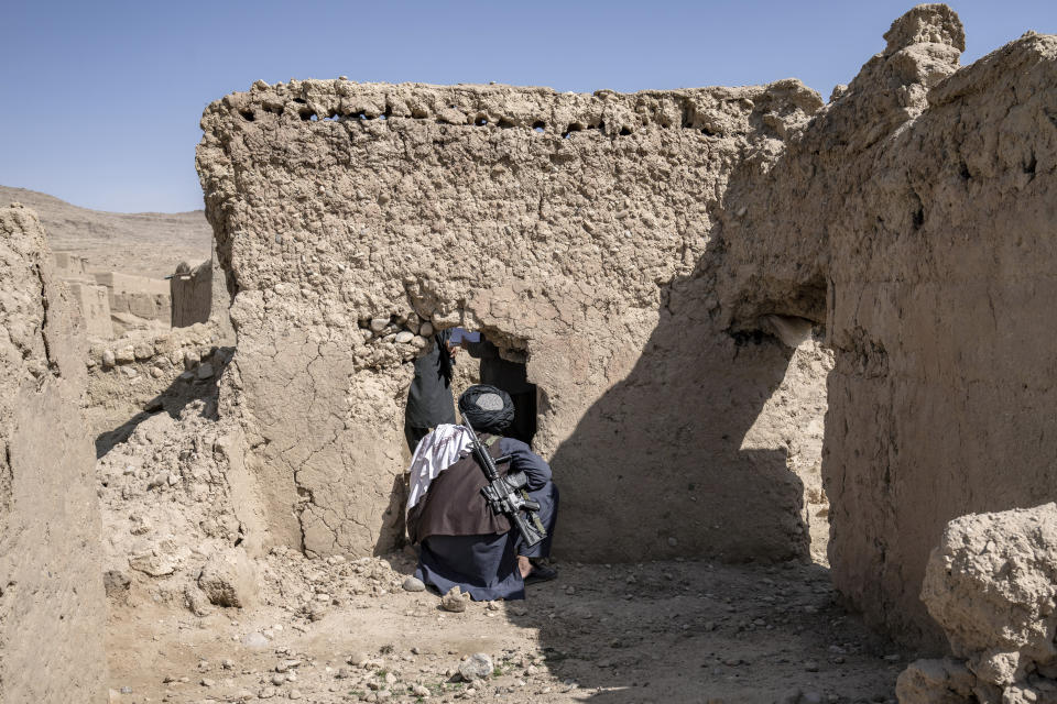 A Taliban fighter looks at a home that was destroyed during a Sept. 5, 2019, night raid by U.S. forces in a village in a remote region of Afghanistan, on Friday, Feb. 24, 2023. U.S. soldiers picked up an infant in the rubble after the raid; she’s now at the center of a bitter, international custody dispute. (AP Photo/Ebrahim Noroozi)