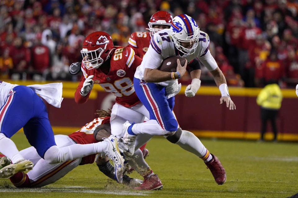 Buffalo Bills quarterback Josh Allen (17) runs with the ball as Kansas City Chiefs defensive tackle Tershawn Wharton (98) defends during the second half of an NFL football game Sunday, Dec. 10, 2023, in Kansas City, Mo. (AP Photo/Ed Zurga)