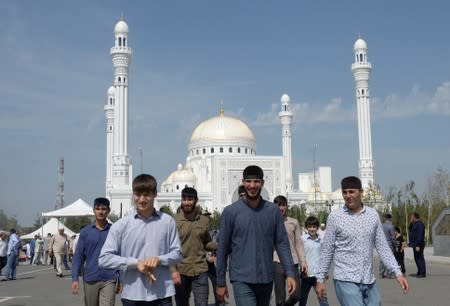 People walk near a mosque after an inauguration ceremony in Shali