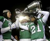 Saskatchewan Roughriders Paul Woldu holds the Grey Cup after his team defeated the Hamilton Tiger Cats to win the CFL's 101st Grey Cup championship football game in Regina, Saskatchewan November 24, 2013. REUTERS/Todd Korol (CANADA - Tags: SPORT FOOTBALL)