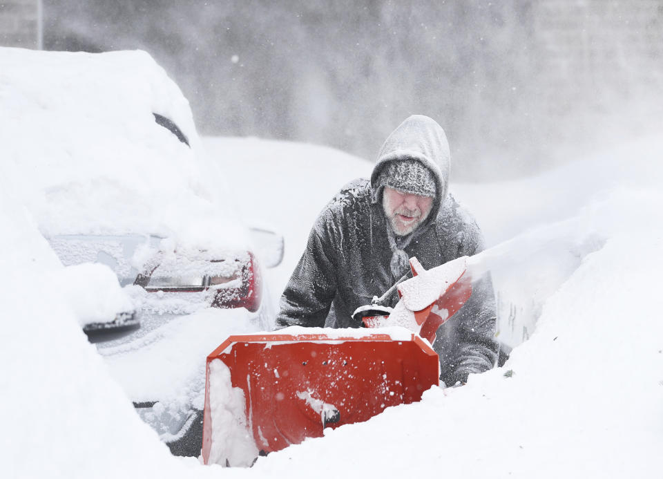 Mike Gippon plows snow in the driveway outside his home in Buffalo, N.Y.'s Elmwood Village on Monday, Dec. 26, 2022. Clean up is currently under way after a blizzard hit four Western New York counties. (Joseph Cooke/The Buffalo News via AP)