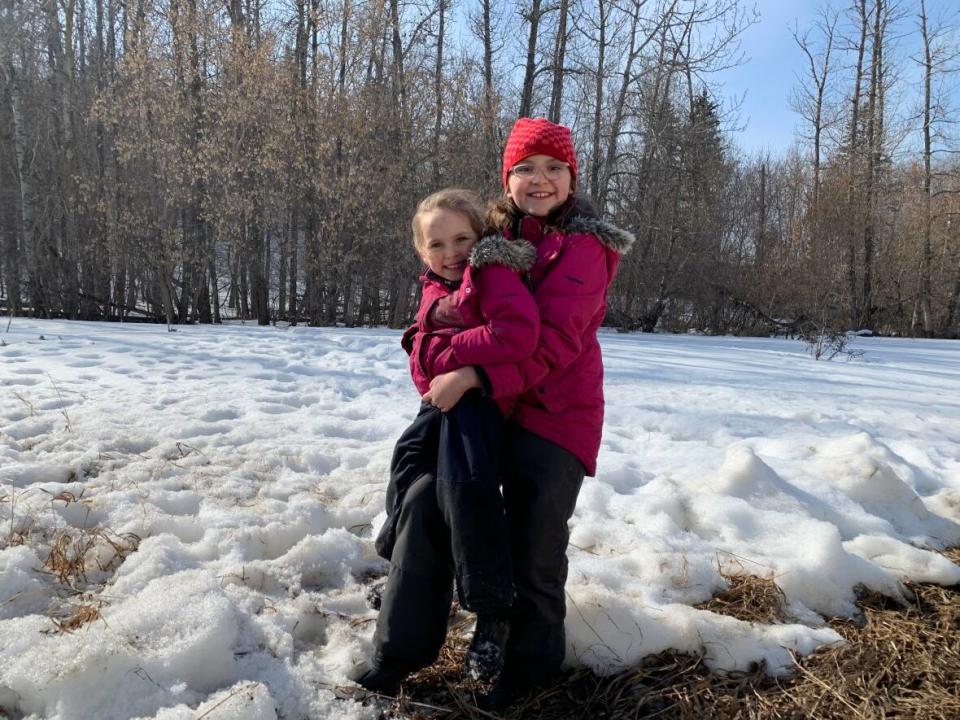 Oleva McRae, right, says it's more relaxing to go to school outdoors in the fresh air. (CBC News - image credit)