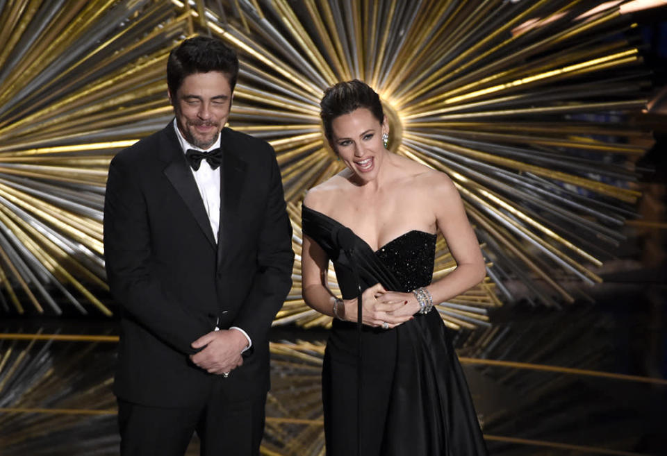 Benicio del Toro, left, and Jennifer Garner speak at the Oscars on Sunday, Feb. 28, 2016, at the Dolby Theatre in Los Angeles. 