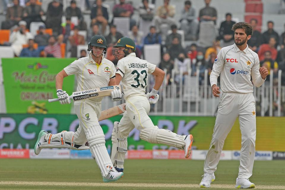 Australia's Stave Smith (pictured left) and teammate Marnus Labuschagne (pictured middle) run between the wicket.